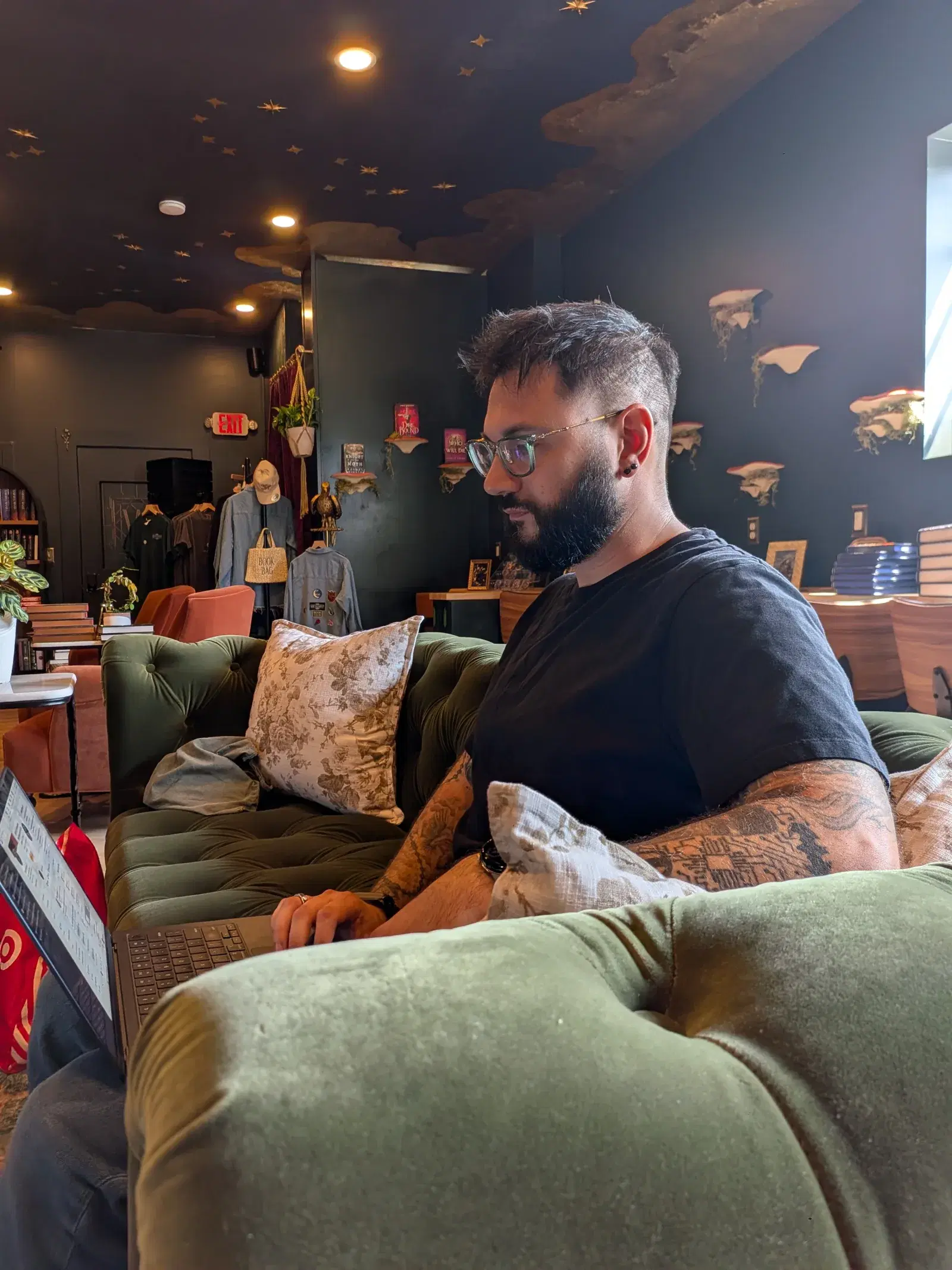 Matt working on a laptop in an independent bookstore